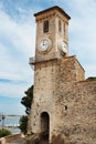 Old tall clock tower on blue sky background with sea view Royalty Free Stock Photo