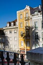 Tall colorful buildings with Palm tree shadow