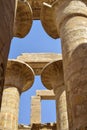 Tall columns of historical complex of Karnak temple with carved ancient Egyptian hieroglyphs and symbols. Great Hypostyle Hall Royalty Free Stock Photo