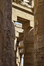 Tall columns of historical complex of Karnak temple with carved ancient Egyptian hieroglyphs and symbols. Royalty Free Stock Photo