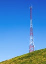Tall Communication Tower on a Hill With Blue Sky Royalty Free Stock Photo