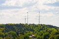 Tall communications masts towering above a forest.. Royalty Free Stock Photo