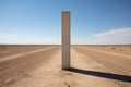 tall concrete boundary marker in the middle of a desert