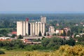 Tall concrete storage silos made as one large building at local industrial complex with cell phone antennas and transmitters on