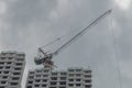 tall crane towering over a half constructed multistory flat