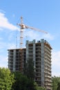 Tall crane works near tall residential building