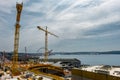 Tall cranes and Seattle waterfont with ferris wheel surround construction Royalty Free Stock Photo