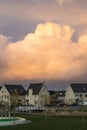 Tall cumulus cloud is illuminated at sunset