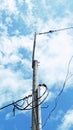 tall electric poles standing with the cloudy sky