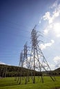 Tall electrical transmission towers at hydro-electric dam Royalty Free Stock Photo