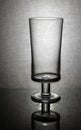 empty beer glass with reflection on textured gray background Royalty Free Stock Photo