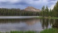 Tall evergreen trees by scenic Crystal lake in Uinta Wasatch national forest Royalty Free Stock Photo