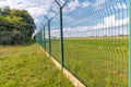 Tall fence with barbed wire angle shot Royalty Free Stock Photo