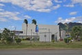 Tall fence surrounding Fiji Water bottled water factory with mountain background at the north of Viti Levu, Fiji