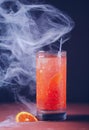 Tall glass of blood orange cocktail with white smoke Royalty Free Stock Photo