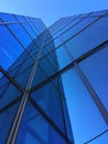 A tall glass building against a blue sky with reflection Royalty Free Stock Photo