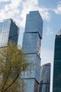 A tall glass business building with large windows.