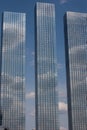 A tall glass business building with large windows.