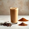 Tall Glass of Coffee Smoothie with Coffee Beans and Cocoa Powder Royalty Free Stock Photo