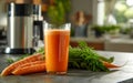 A tall glass of freshly made carrot juice is paired with a high-powered blender in the background, showcasing the tools