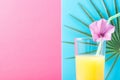 Tall Glass with Freshly Squeezed Pineapple Citrus Tropical Fruit Juice with Straw and Flower. Pink and Blue Background Palm Leaf Royalty Free Stock Photo
