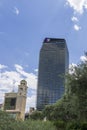 A tall glass hotel and the Bellagio hotel with lush green trees and a gorgeous blue sky with clouds in Las Vegas Nevada Royalty Free Stock Photo