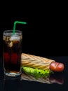 Tall glass of iced coke with a hot dog Royalty Free Stock Photo