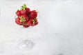 A tall glass vase or wine glass with fresh strawberries. Natural product. Copy of the space. Food for vegetarians. Flat layout.Top