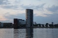 Tall grain silo with its reflection in the river in Aalborg, Denmark