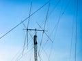 A Tall ham radio antenna against blue sky Royalty Free Stock Photo