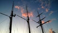 A tall, handsome dark masts of an old ship on the background of purple colored sunset sky. Romantic journey Royalty Free Stock Photo