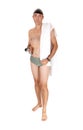 Young man in a swimsuit standing with his towel Royalty Free Stock Photo