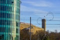 Tall Hermann Tower with Estonian flag in the Old Town. New modern green glass building on the left. Tallinn, Estonia Royalty Free Stock Photo