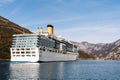 A tall, high-rise huge cruise liner in the Verige Strait, in the Boka Kottorska - Kotor Bay in Montenegro, against the