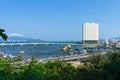 Tall hotel by the sea and boats in the port under the bridge in the tropics Royalty Free Stock Photo