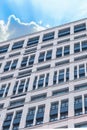 Tall house glass windows modern vertical photo on the sky background close up Royalty Free Stock Photo