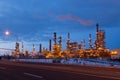 Tall illuminated oil refinery chimneys and installations seen from the street, LÃÂ©vis