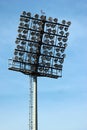 Tall lamp post, stadium light or sports lighting against blue sky background Royalty Free Stock Photo