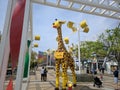 Tall Lego giraffe stands on a street in Osaka, Japan