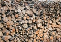 Tall long stack of cut firewood logs of various thickness neatly piled together Royalty Free Stock Photo