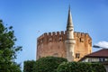 A tall minaret against the background of an old fortress in Alanya. Clear blue sky on a sunny day. Space for text Royalty Free Stock Photo