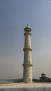 The tall minaret of the ancient Taj Mahal against a clear blue sky. Royalty Free Stock Photo