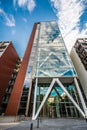 Tall modern building with clouds reflections in the windows. Hamburg, Germany. Royalty Free Stock Photo