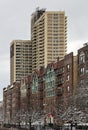 tall modern high rise low income apartment building towering above old pre-war historic apartment buildings in brooklyn Royalty Free Stock Photo