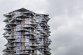 Tall modern residential building against a gray sky. Cactus tower in Copenhagen city. Royalty Free Stock Photo