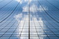 Tall modern skyscraper building with clouds reflected in the glass windows in Manhattan New York City Royalty Free Stock Photo