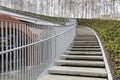 Modern winding staircase with railings in a birch grove