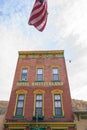 Tall narrow structure of red brick Hotel Switzerland building displaying its balanced architectural features from low point of