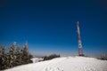 Tall observation tower stands on a snowy hill Royalty Free Stock Photo