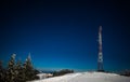 Tall observation tower stands on a snowy hill Royalty Free Stock Photo